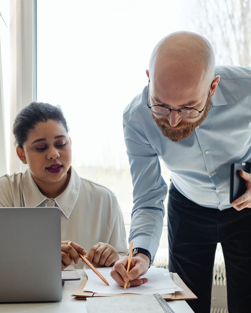 Two colleagues working through a document together