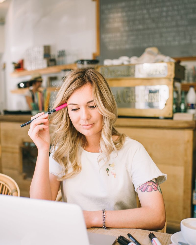 A café owner reviewing her business at her counter